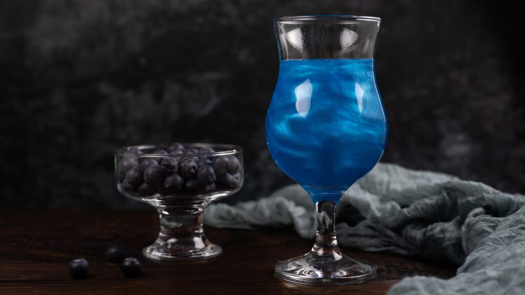 blue cocktail made with edible glitter 